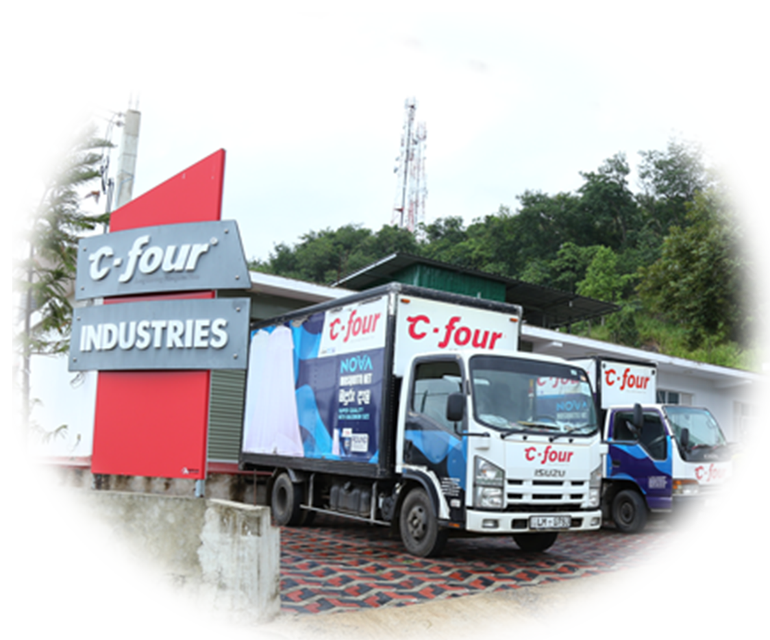 The C-Four Industries factory sign and delivery trucks in Mawanella